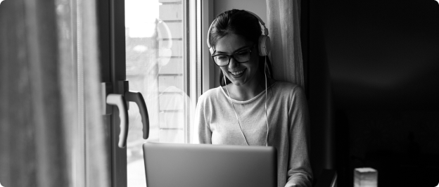 Person with headphones on laptop